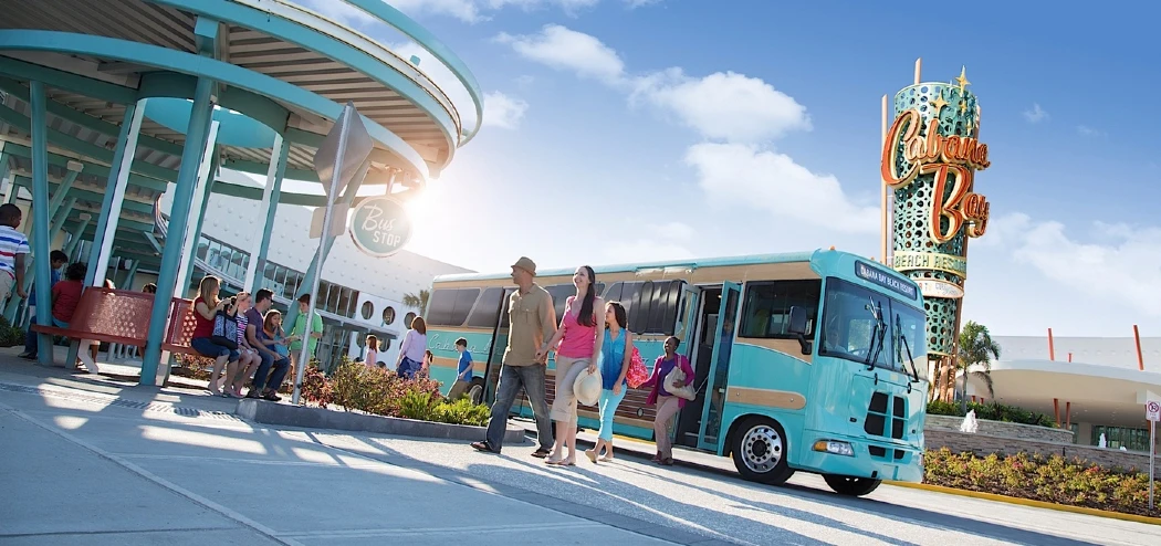 A bus drops the passengers and waits at the Cabana Bay Beach Resort station