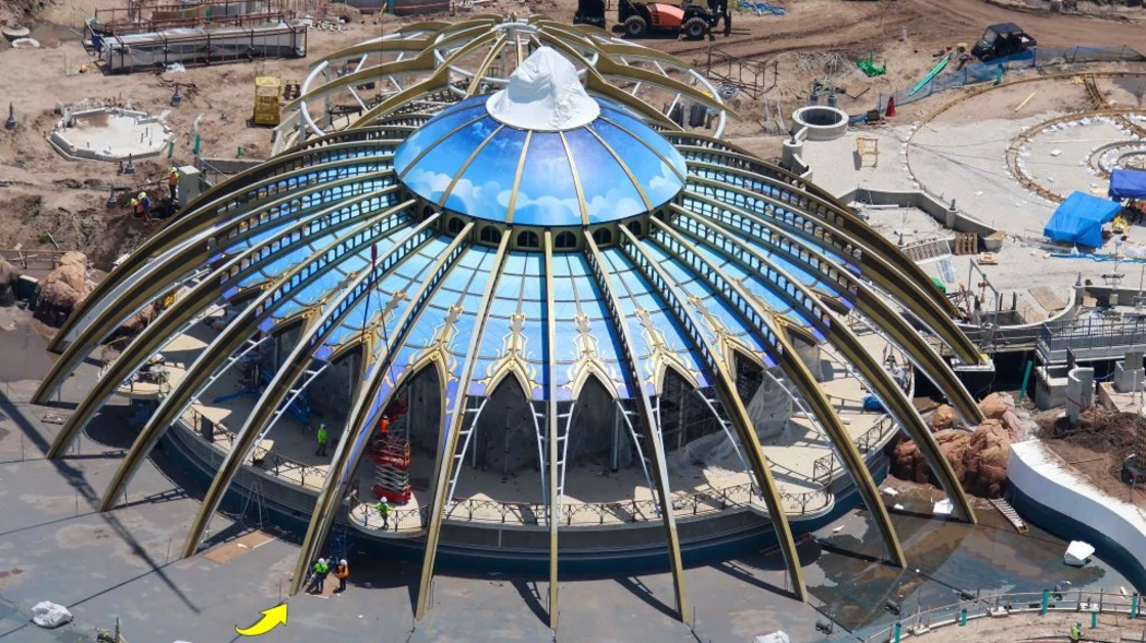 Aerial view of a domed structure with a colorful ceiling