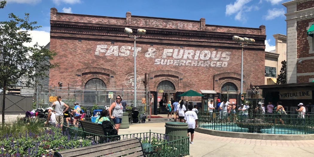 Entrance gate of fast and furious supercharged attraction with people waiting to enter