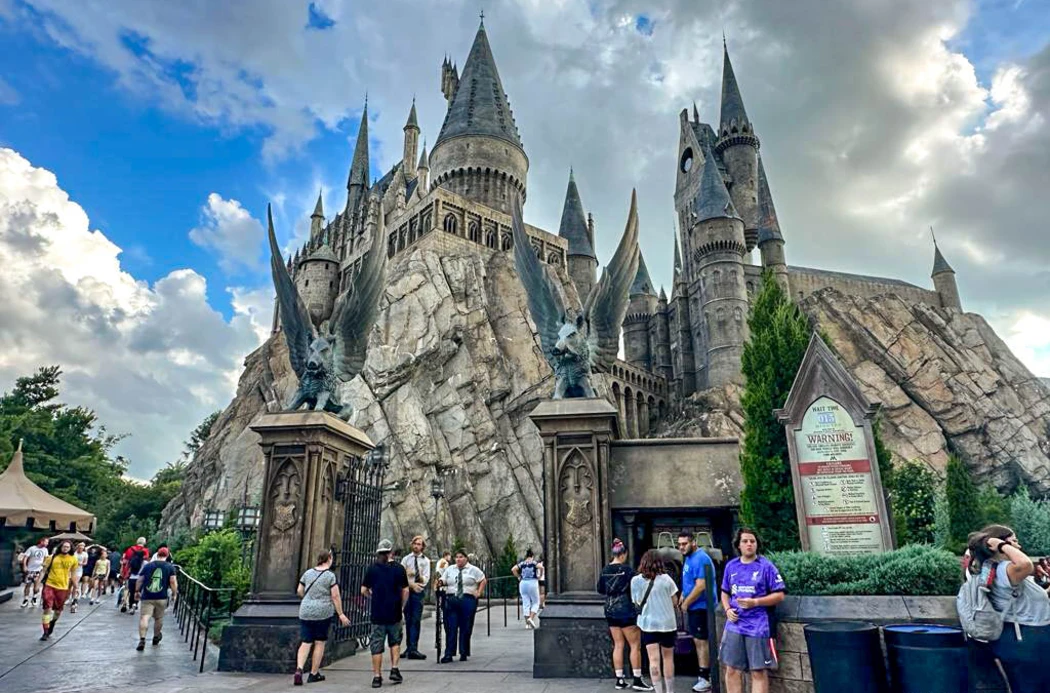 Tourists visiting Hogwarts in a magical theme park