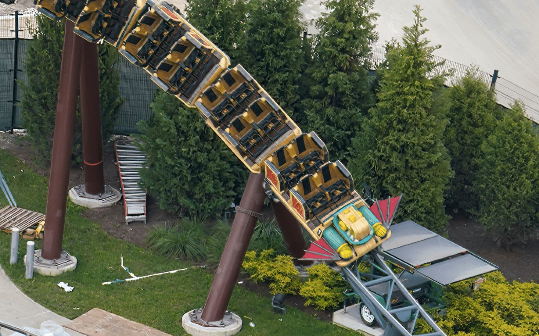 A roller coaster train suspended upside down on a track