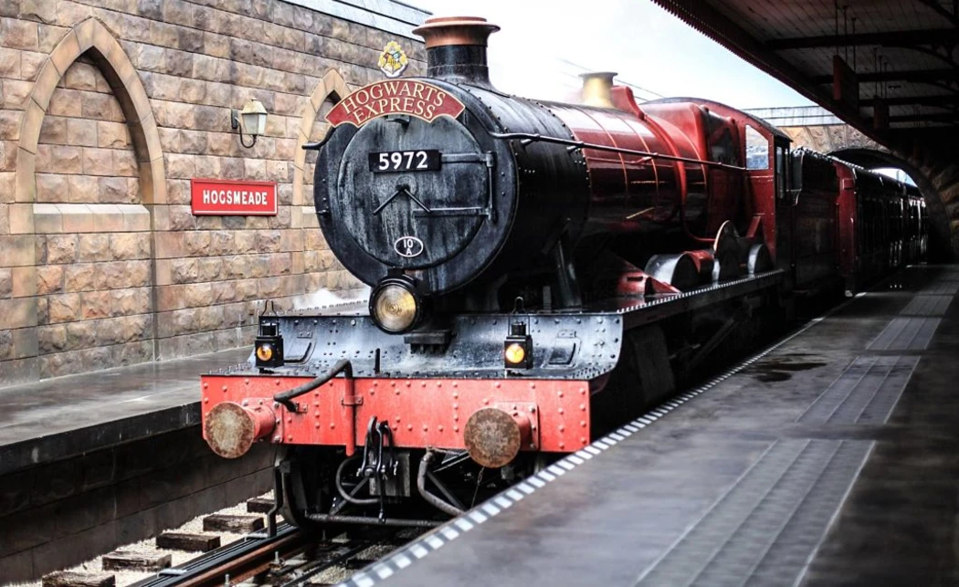 A red and black color Hogwarts Express train waiting at the platform