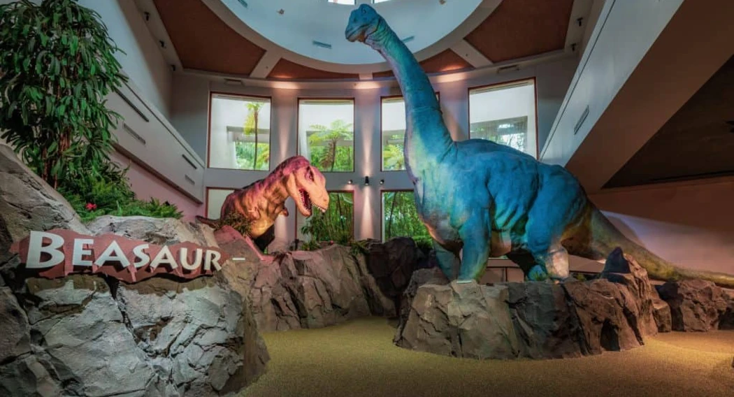Colorful dinosaur sculptures, including a T-rex and a brontosaurus