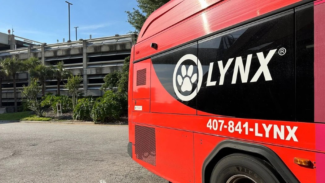 A red color LYNX bus