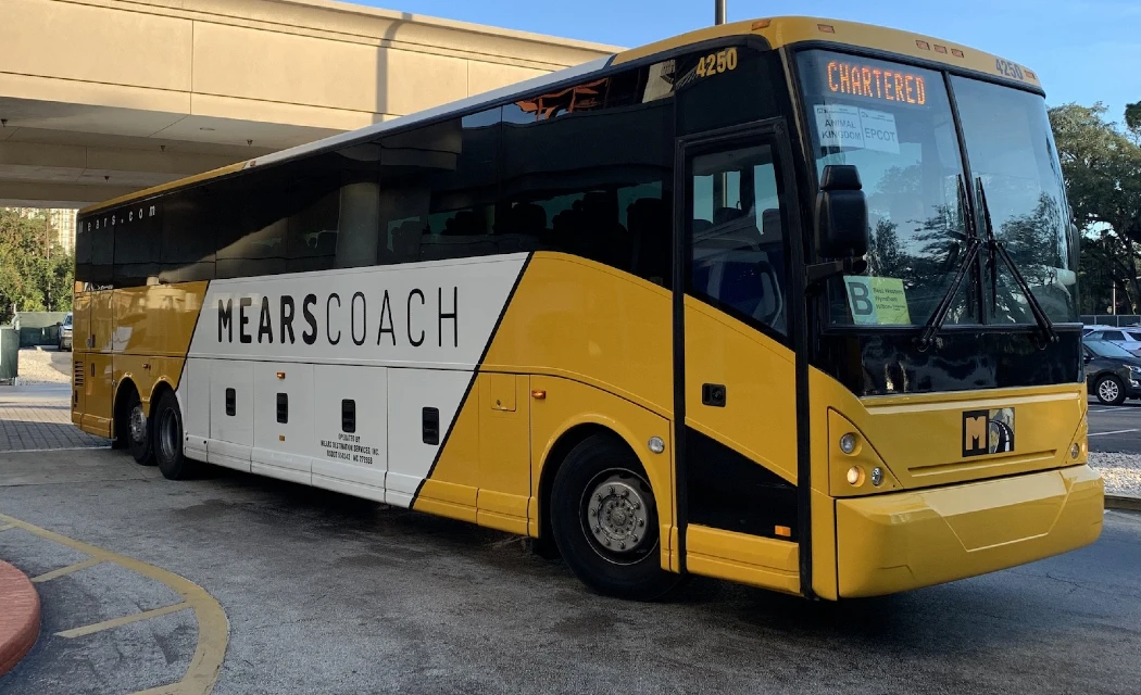 A yellow and white color Mears Coach bus