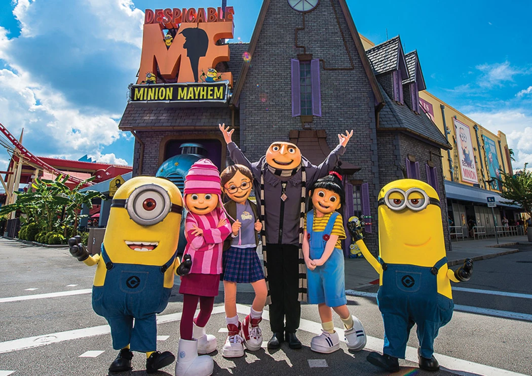 Minions and characters from Despicable Me Minions and characters from "Despicable Me" in front of a themed attraction, with a sunny blue sky above