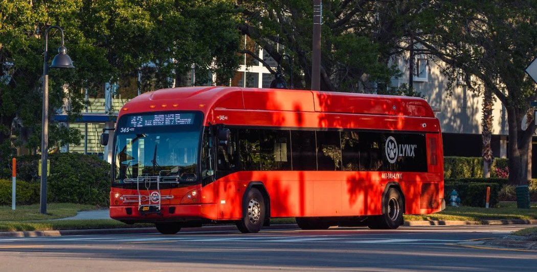 A red Lynx bus displaying route information on its electronic board
