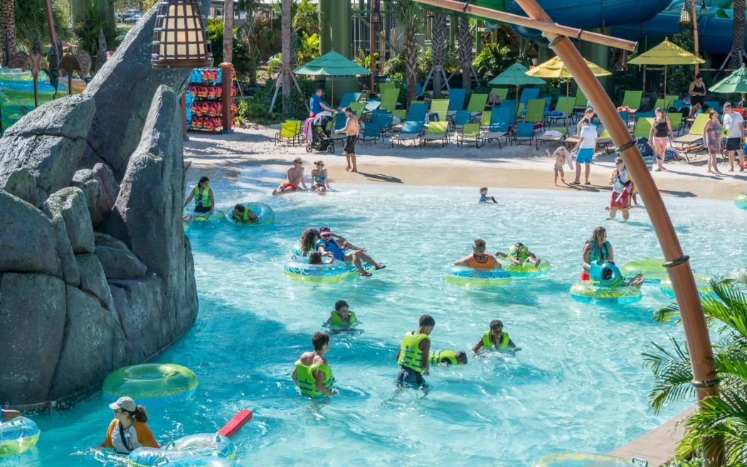 A pool in Volcano Bay where people swimming or floating on tubes