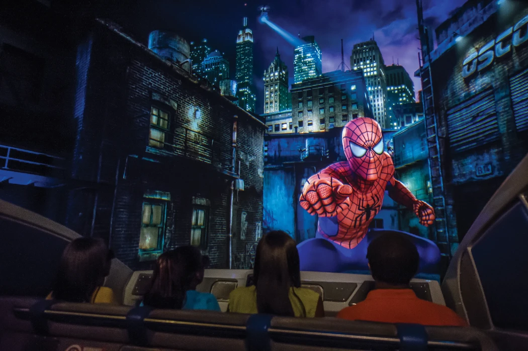 Four visitors watching an animated Spider-Man film