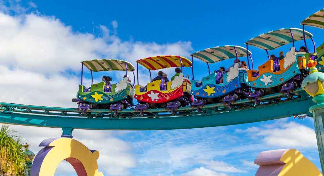 A colorful roller coaster with playful train cars