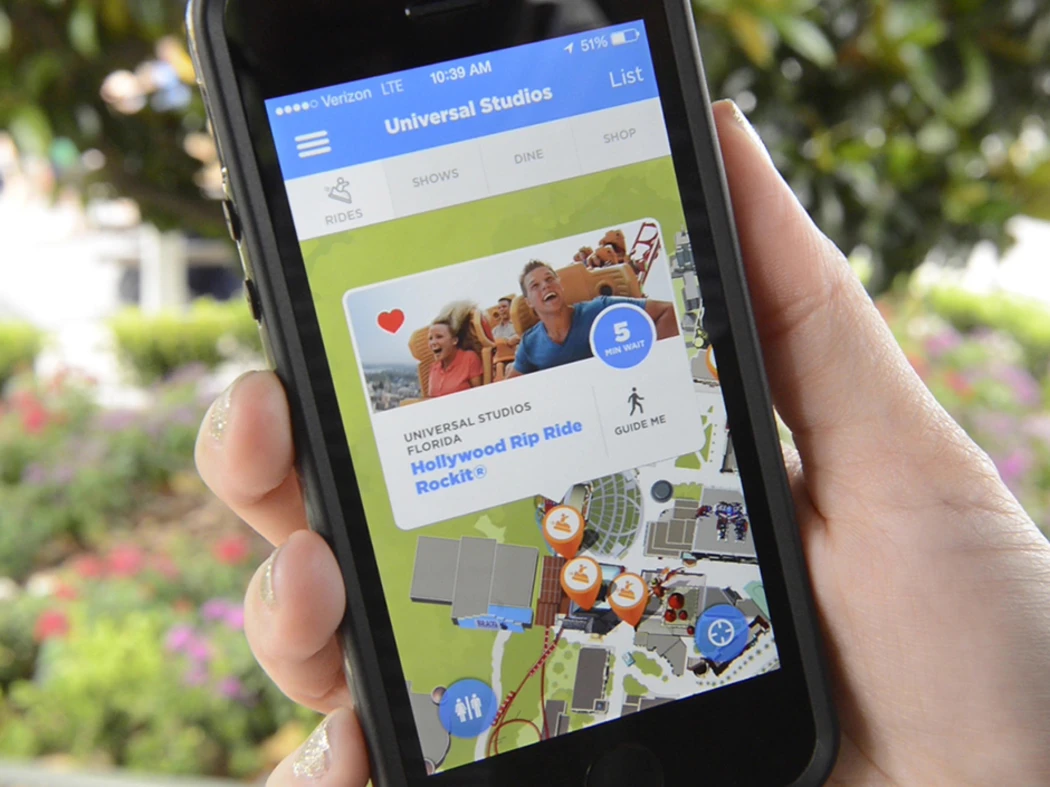 A person holding a mobile phone accessing Universal Studios map
