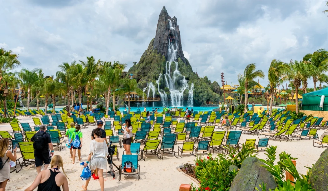 Tropical water park with volcano, waterfalls, and lounge chairs
