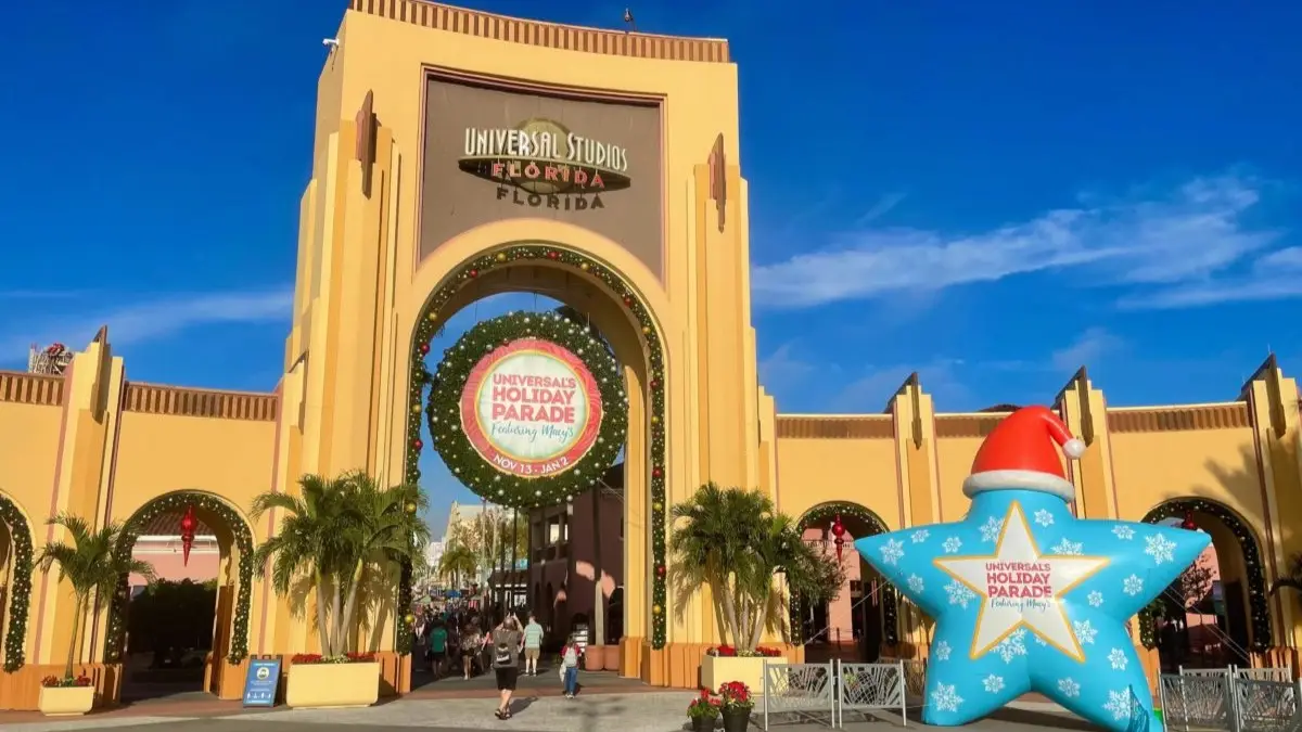 A decorated entrance of Universal Studios Florida with a Universal Holiday Parade star on the right
