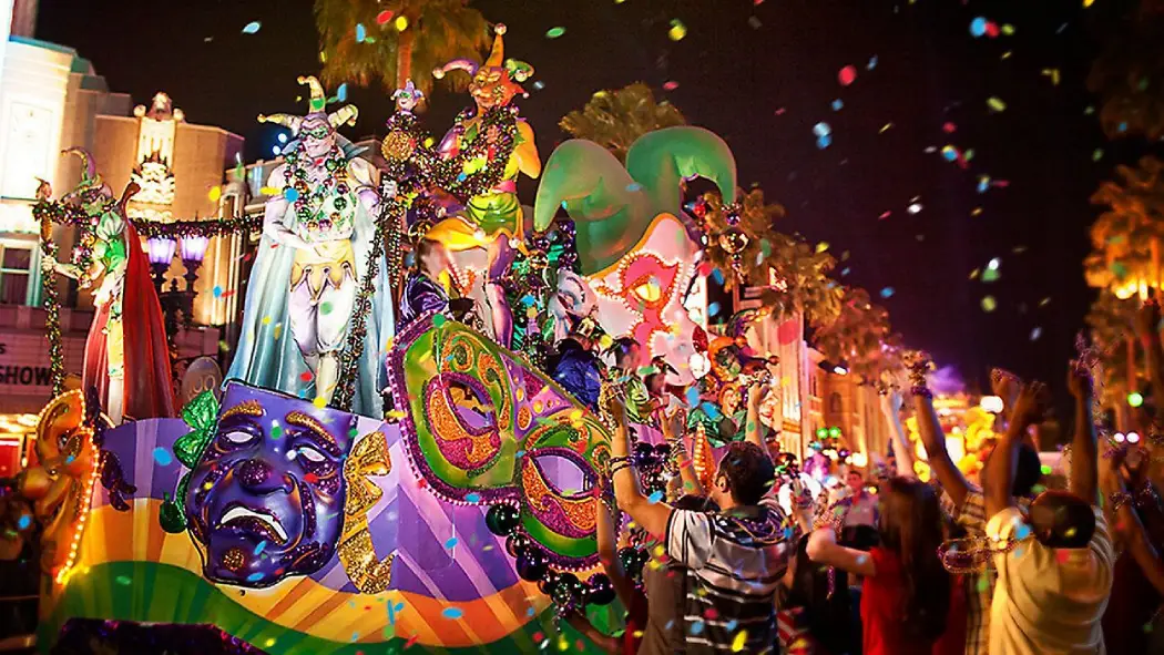 Colorful Mardi Gras float adorned with masks and beads, surrounded by a lively crowd celebrating in a vibrant, festive atmosphere at night