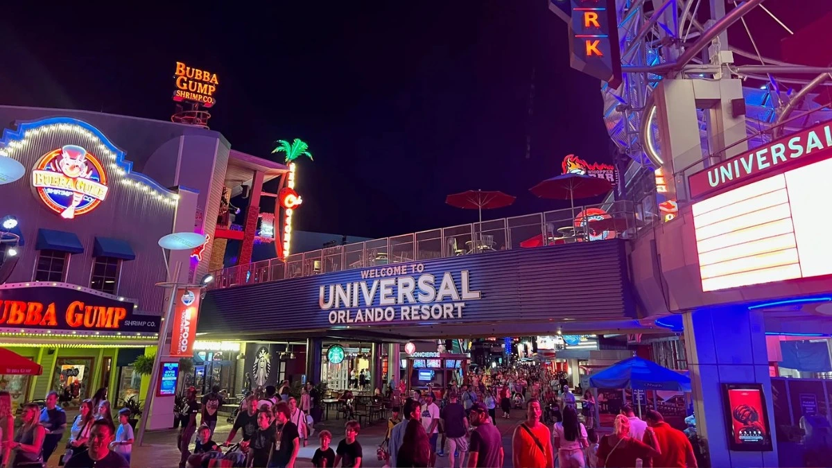 An entrance to Universal Orlando CityWalk with people all around
