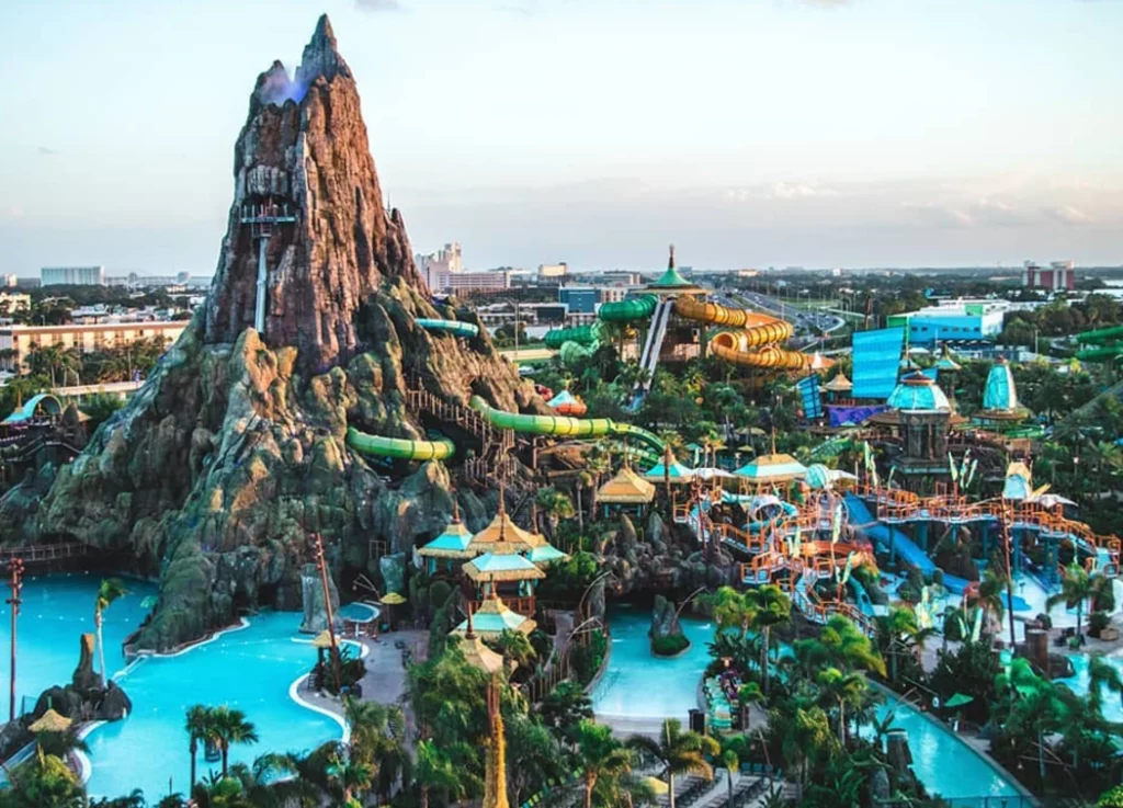 A volcanic mountain surrounded by rides and water in Volcano Bay
